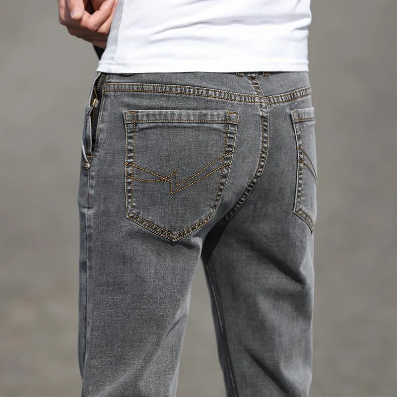 Men's smoky gray straight leg jeans with low waist and zipper fly closure