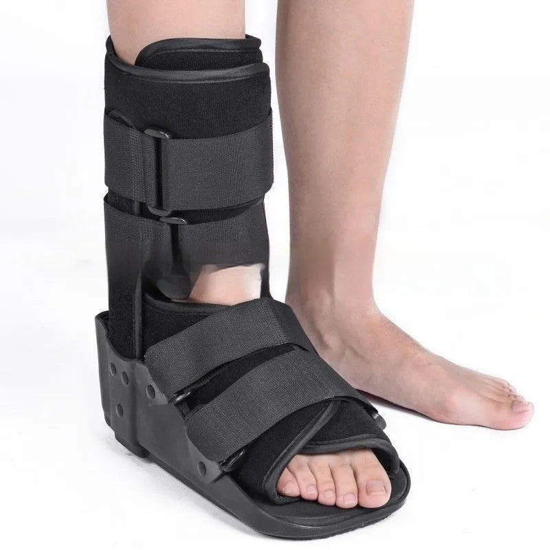 Grey and black Achilles tendon rehabilitation boot with plastic shell, aluminium struts, and adjustable nylon straps.