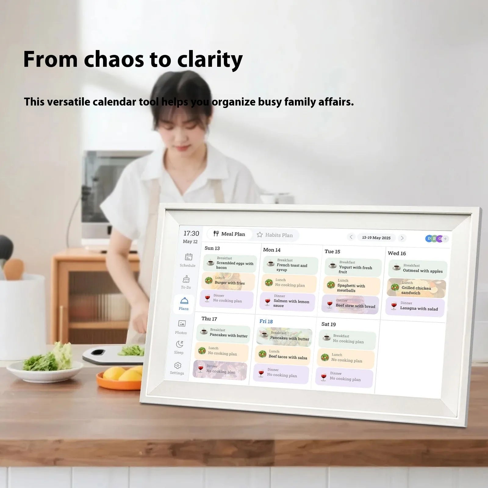 White smart digital photo frame with 15.6 inch screen on a table.