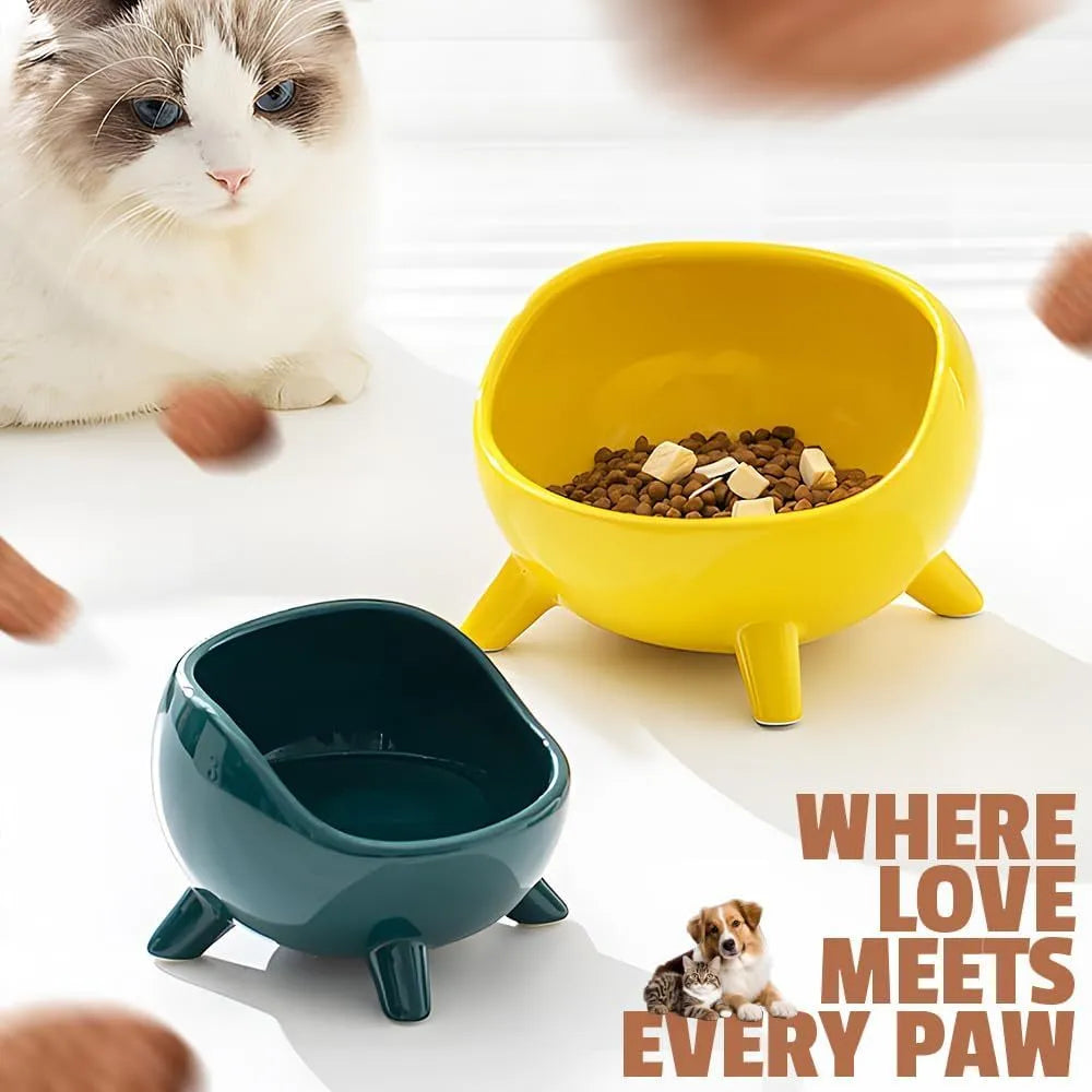 Green ceramic pet food bowl with four legs and a wide, rounded opening.