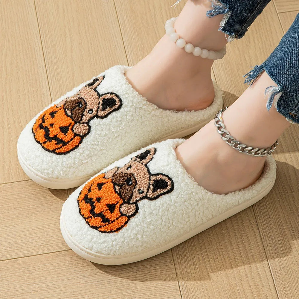 Black and white Halloween slippers with pumpkin pattern, plush upper, and textured rubber sole