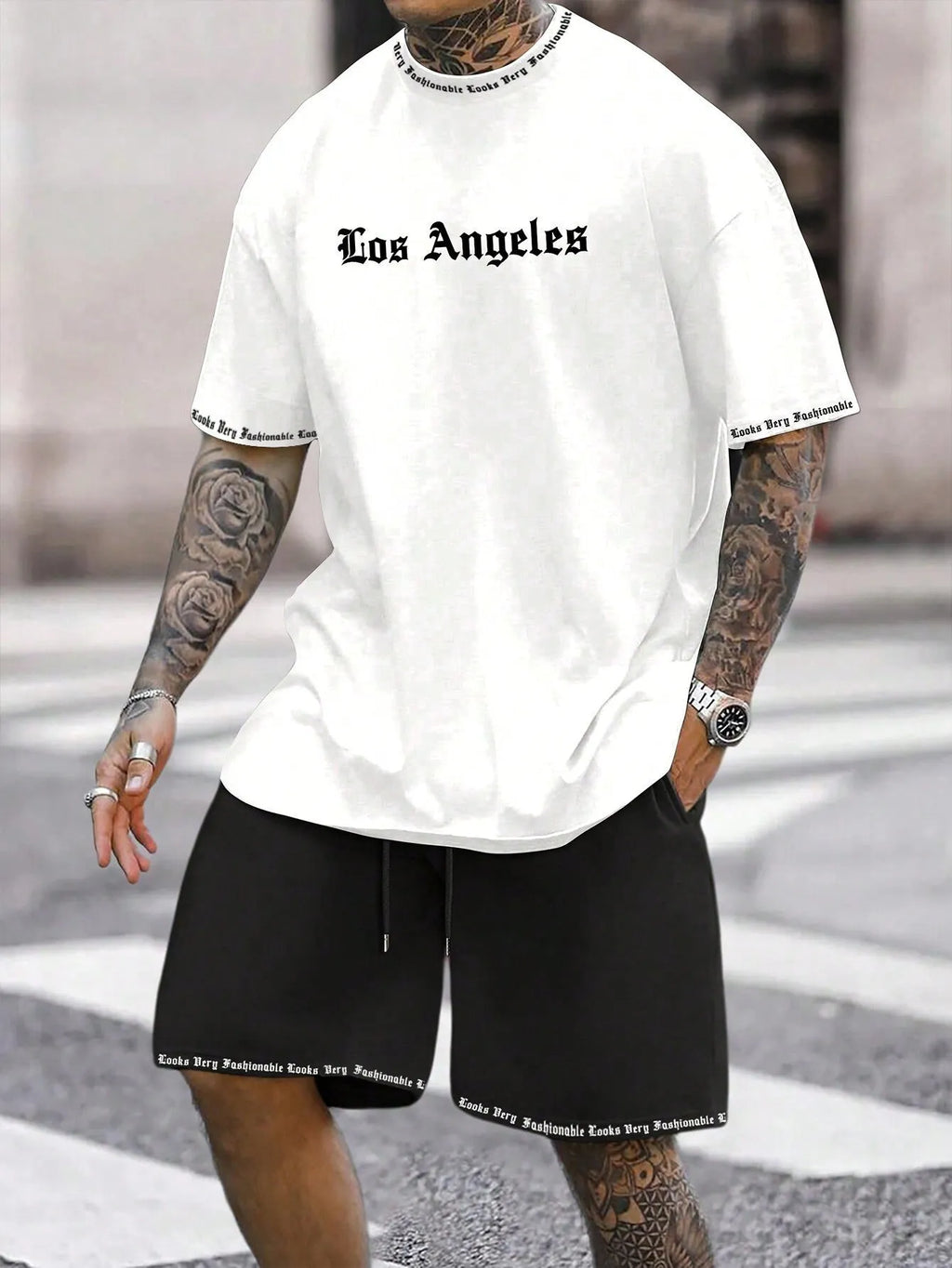 Man wearing a grey short-sleeve top and matching shorts from a sports co-ord set.