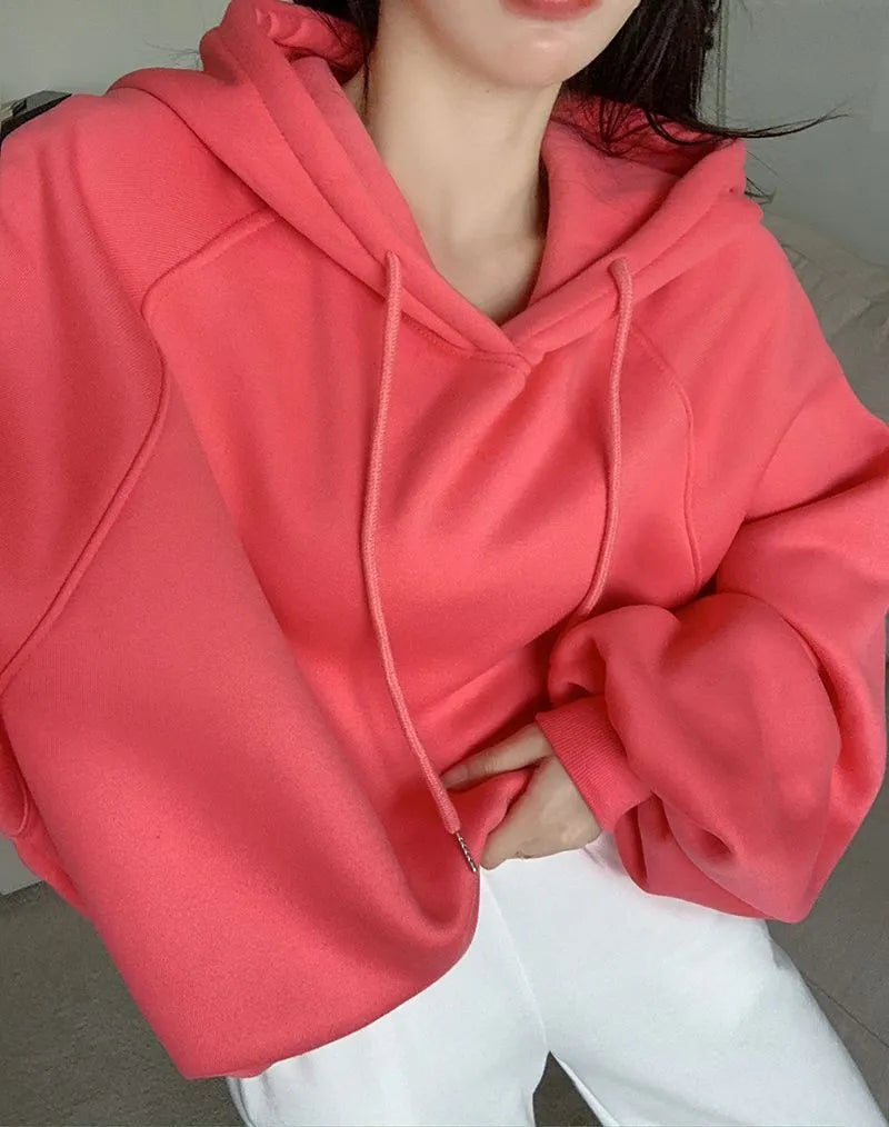 Watermelon red women's sleeveless hooded sweater made from mulberry silk fabric on a hanger.
