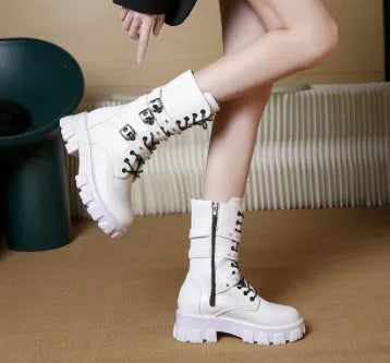 Women's black mid-calf knight boots with metal buckle and side zipper on a round toe.