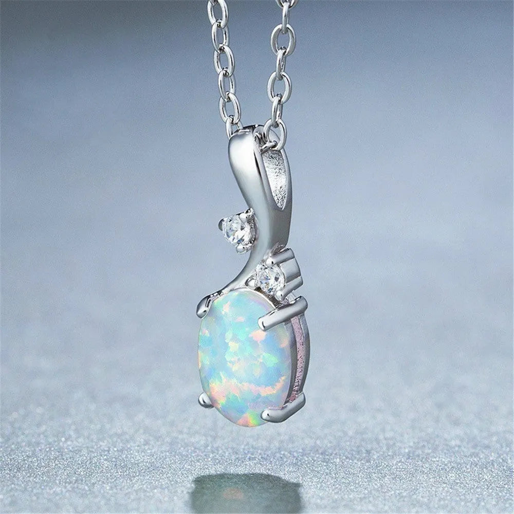 Water drop shaped opal pendant on an adjustable silver tone necklace chain