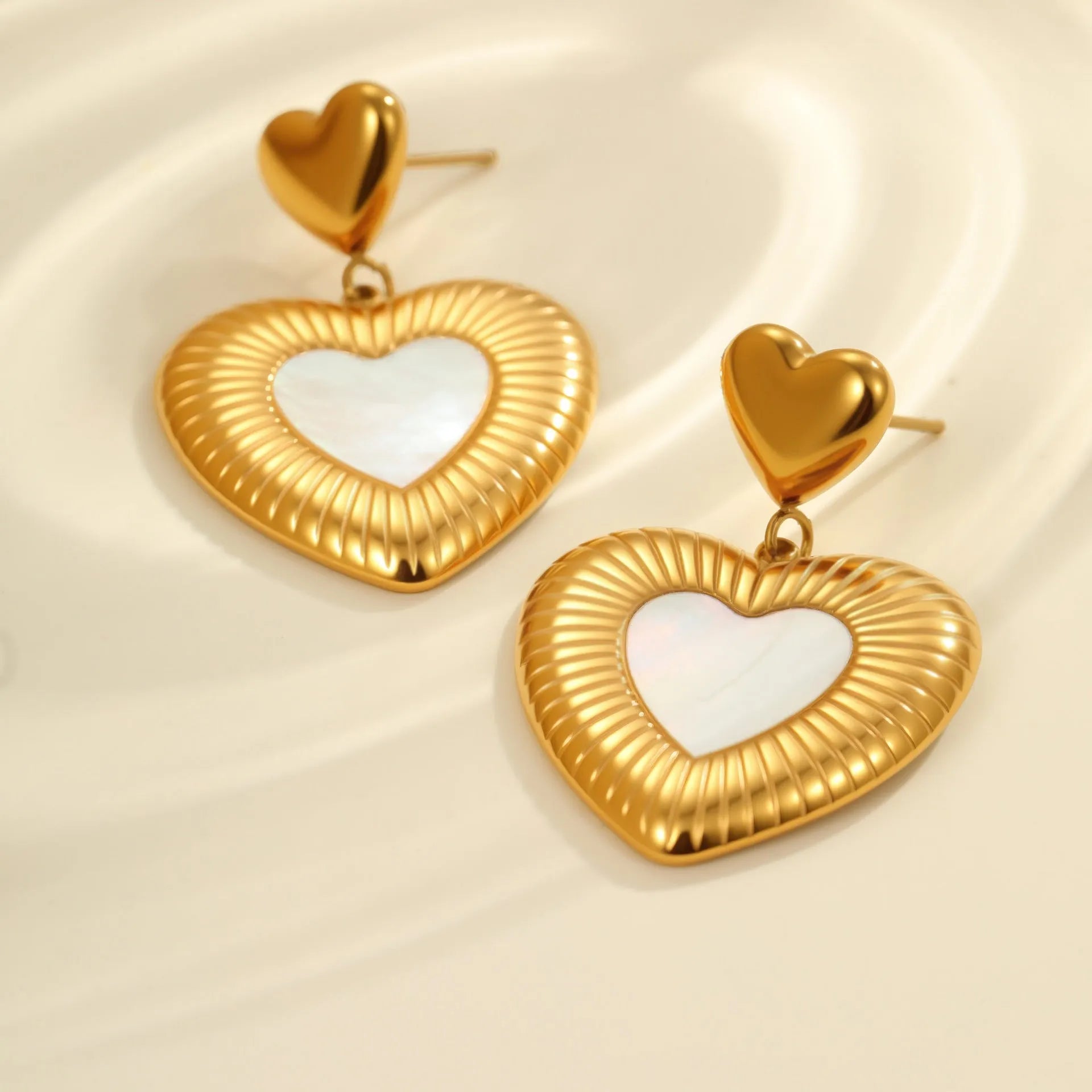 Gold electroplated heart-shaped stainless steel earrings with 18K purity and love element design