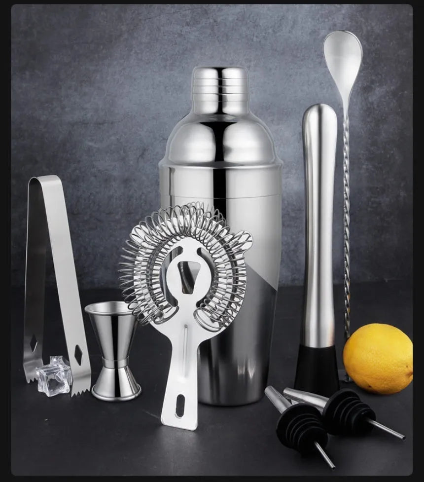 23-piece stainless steel cocktail set with acrylic European-style mixers arranged on bar surface