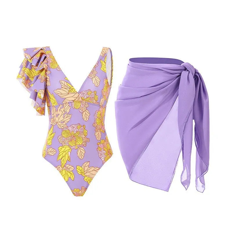 Women's solid colour one-piece swimsuit with thin spaghetti straps and a matching detachable skirt.