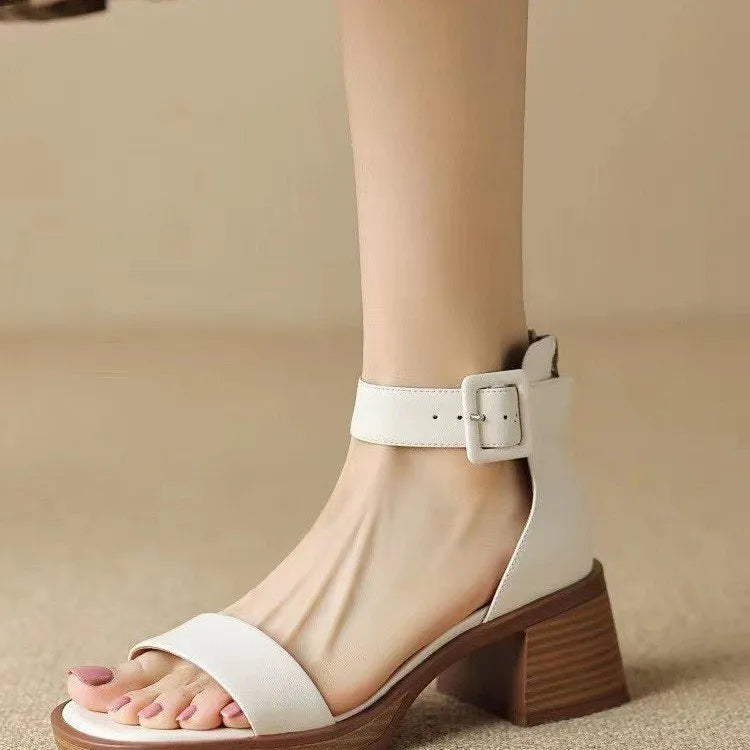 Women's white retro ankle-strap platform high heels with round toe and adjustable buckle.