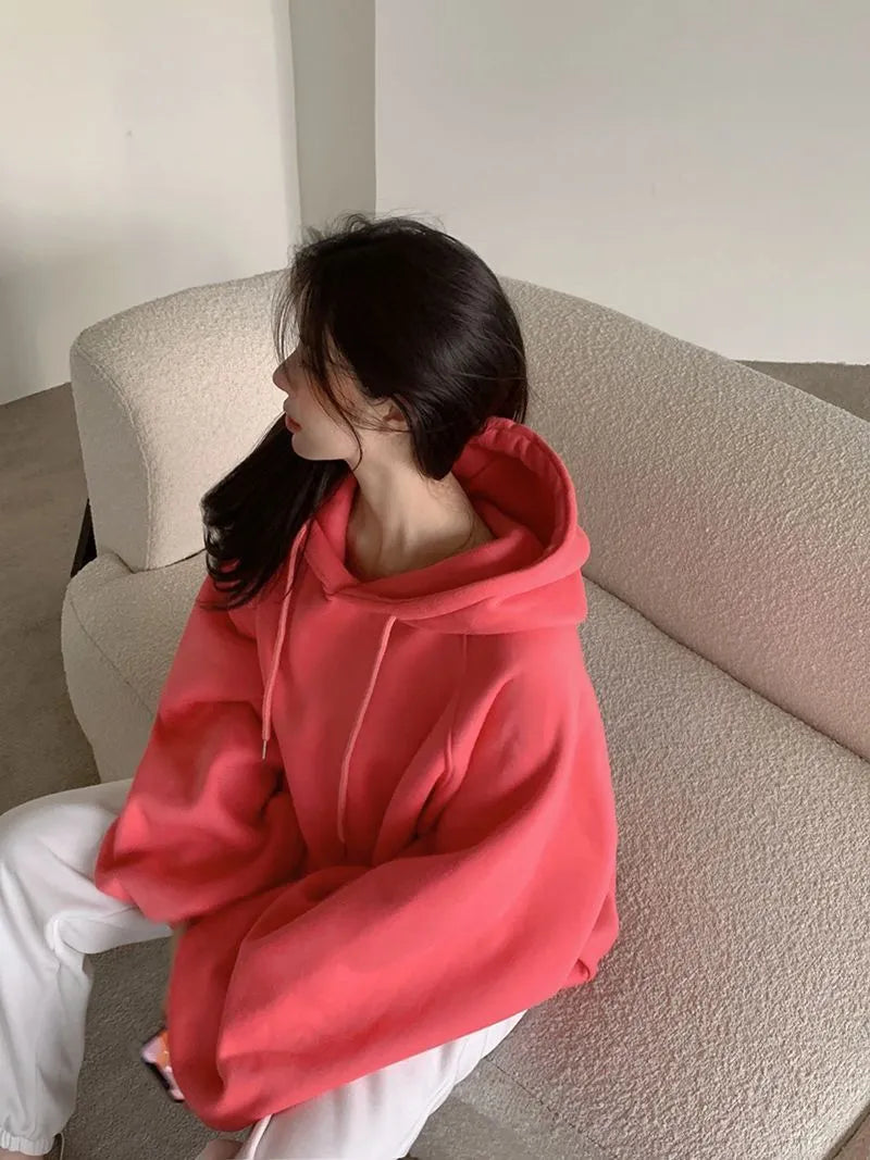 Watermelon red women's sleeveless hooded sweater made from mulberry silk fabric on a hanger.