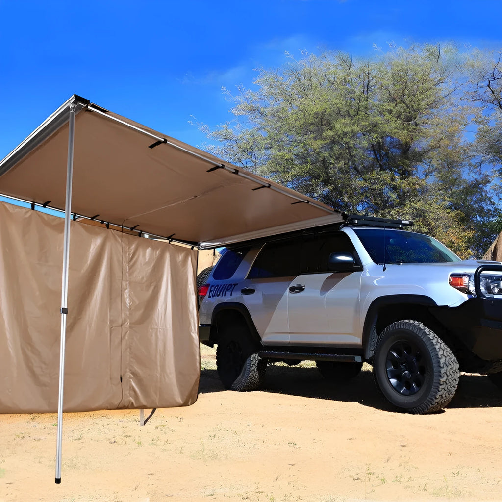 Two-room car camping tent with black glue coated fabric and aluminium poles set up outdoors.