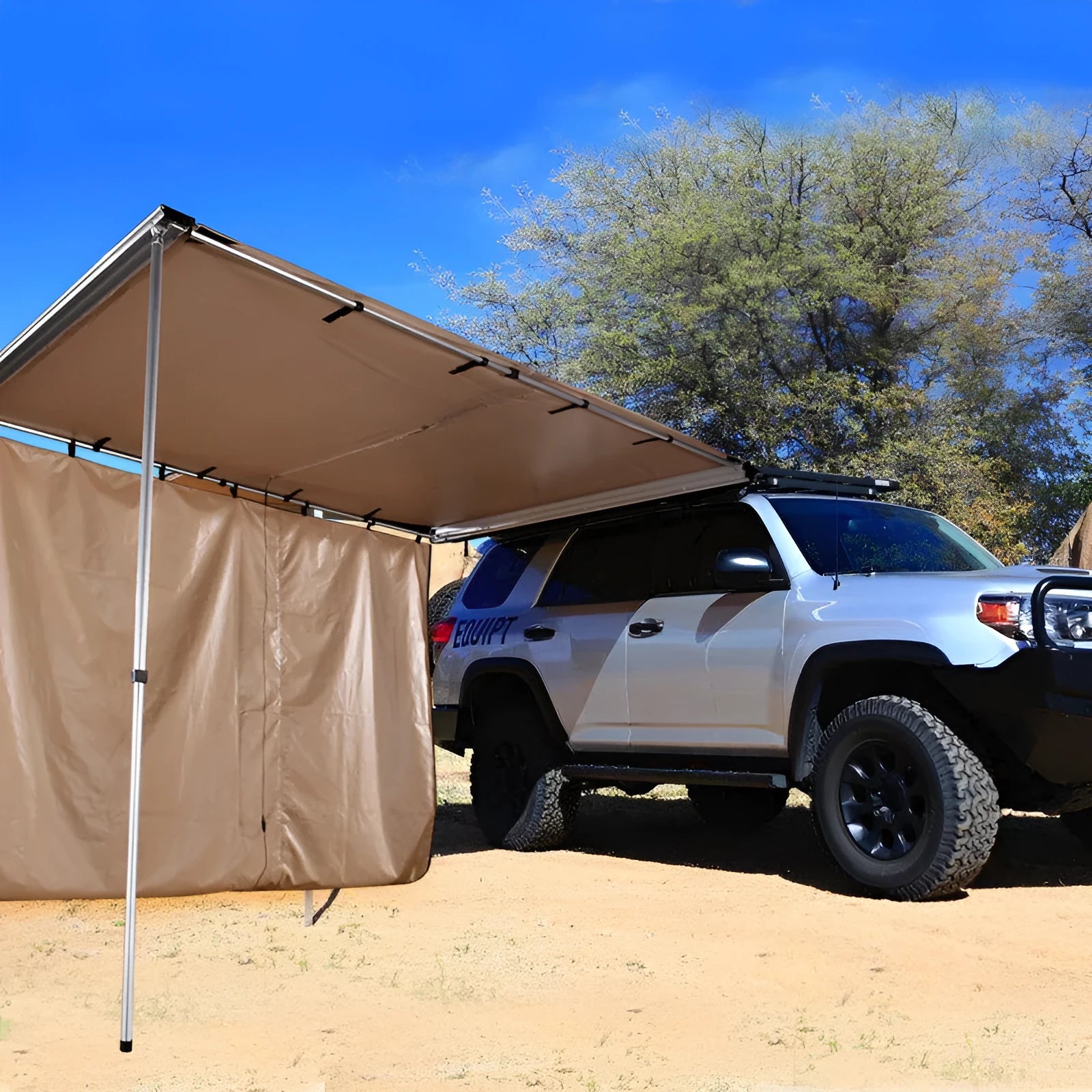 Two-room car camping tent with black glue coated fabric and aluminium poles set up outdoors.