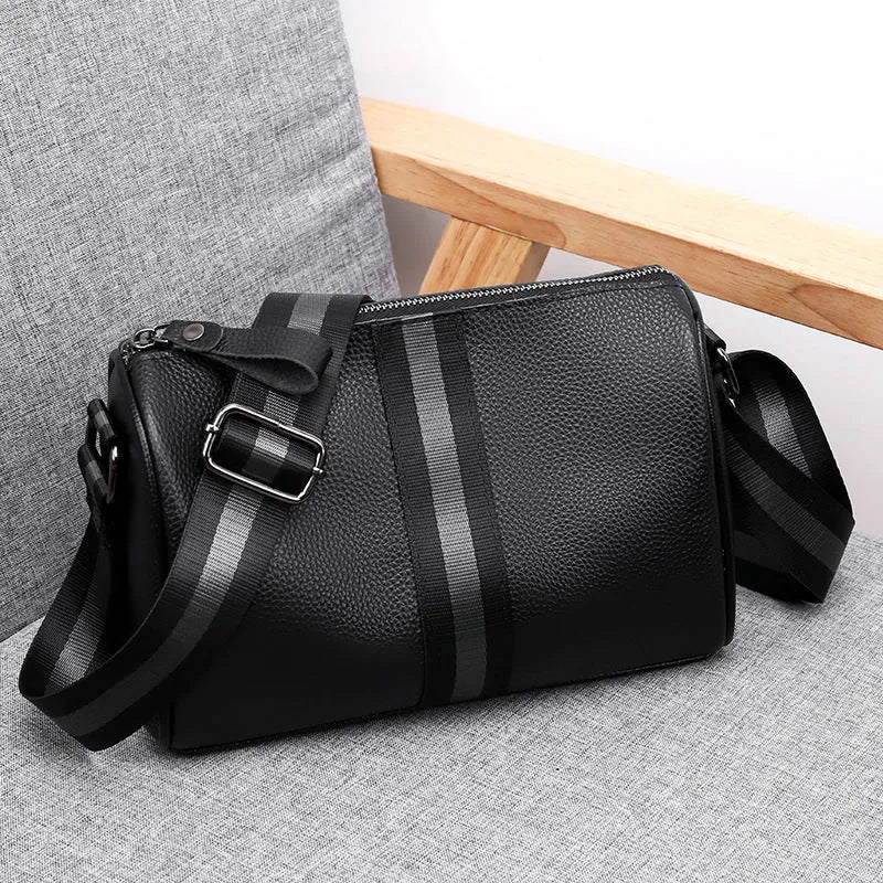 Black genuine leather one-shoulder crossbody bag showing its large size and polyester lining.