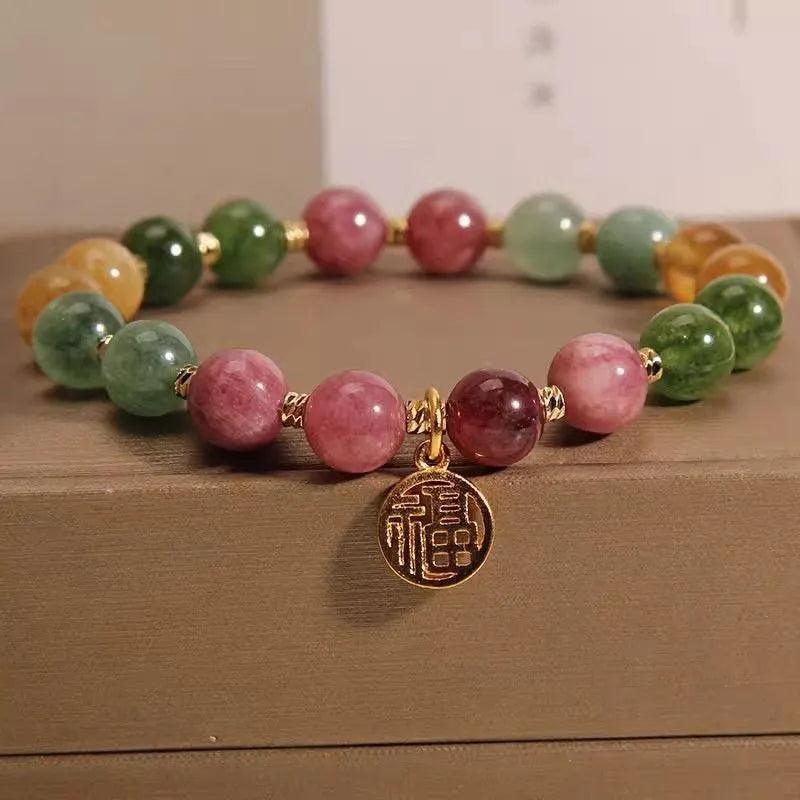 Natural colour tourmaline bracelet with floral and fu character designs and electroplated finish
