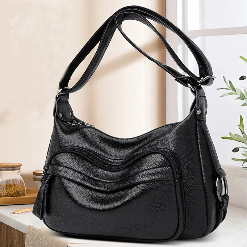 Large black women's shoulder bag with multiple internal organisation pockets and crossbody strap