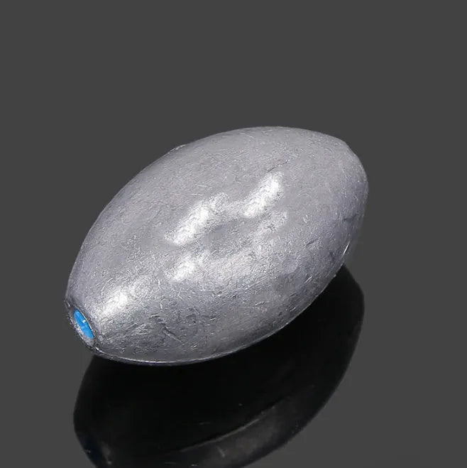 Olive rugby-shaped fishing sinker with scaled texture and plastic core in various weights from 10g to 150g