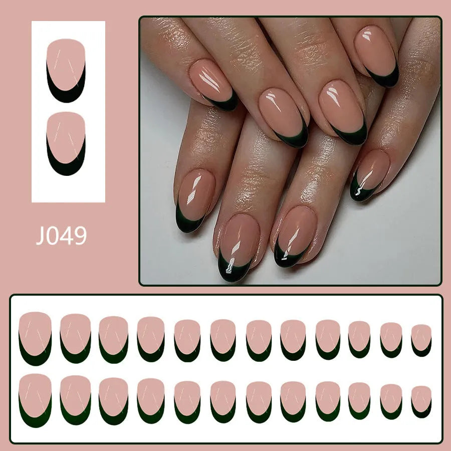 Set of 24 short almond coffin shaped press-on nails with black French tips on a white base.