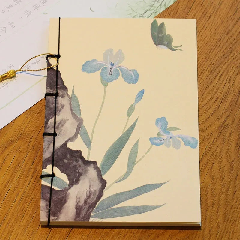 A5 antique wire-bound notebook with retro painting cover, thread binding, and black tassels.