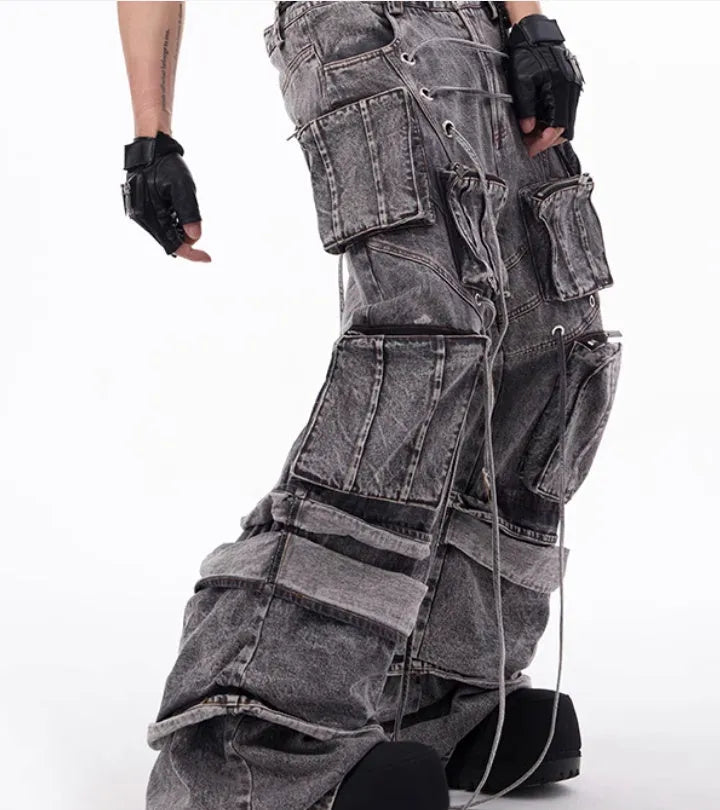 Grey distressed denim overalls with rope stitching and mop pant design on male model