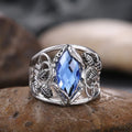 Women's horse eye shaped blue crystal alloy ring on a finger, showing geometric design.
