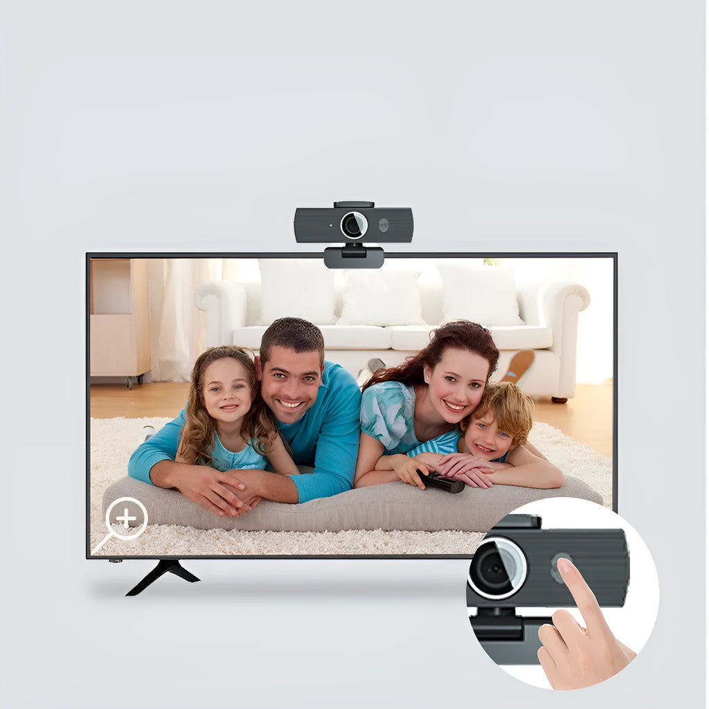 Black USB computer webcam with attached cable and magnetic privacy cover on a desk