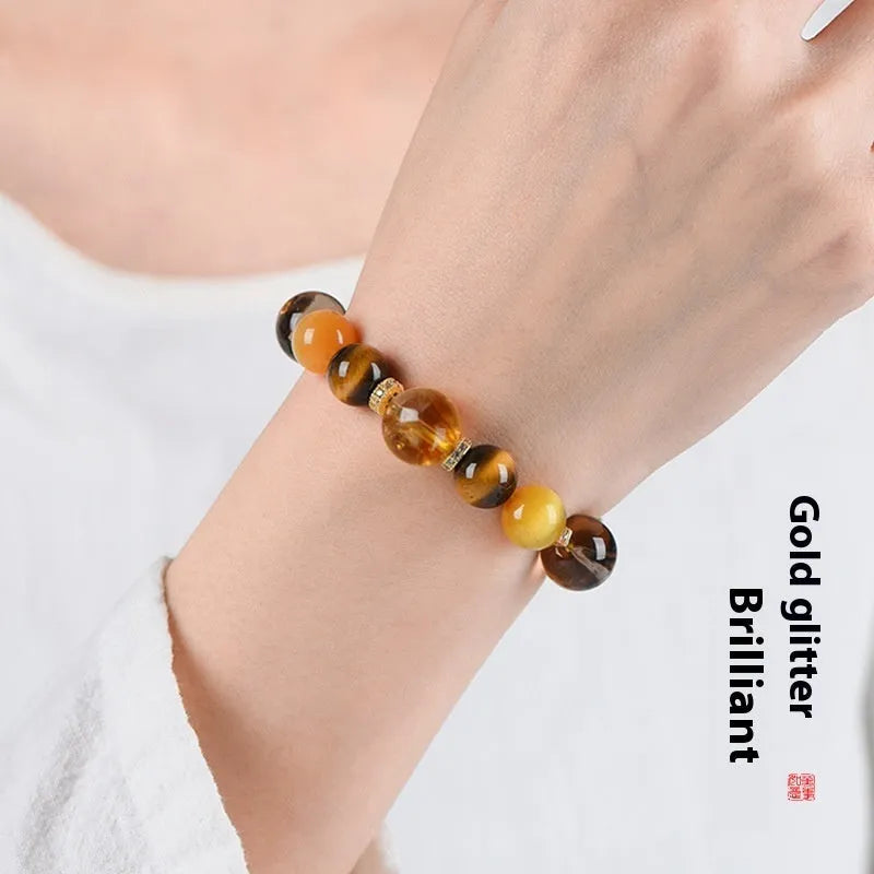 Natural yellow women's bracelet with 10mm artificial crystal string beads on a wrist.