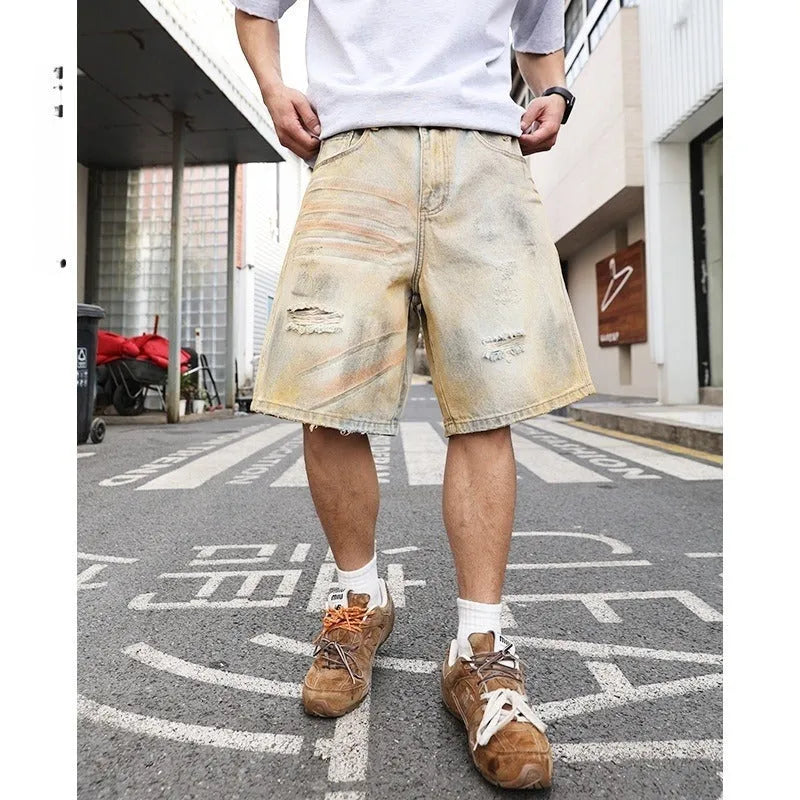 Light blue washed men's denim shorts with ripped details on a straight-leg cut