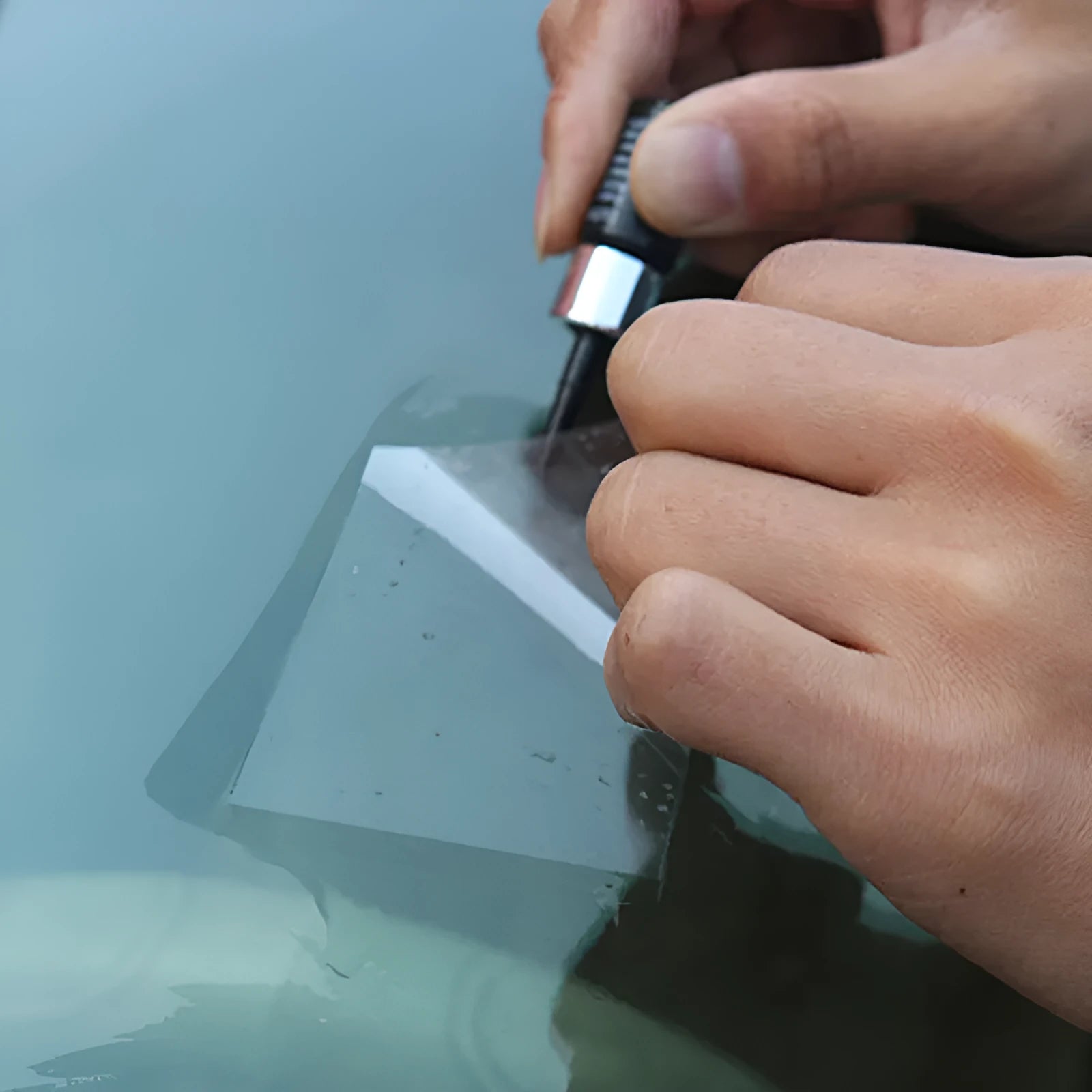 Yellow three-piece car windshield repair kit with glass repair liquid and application tools