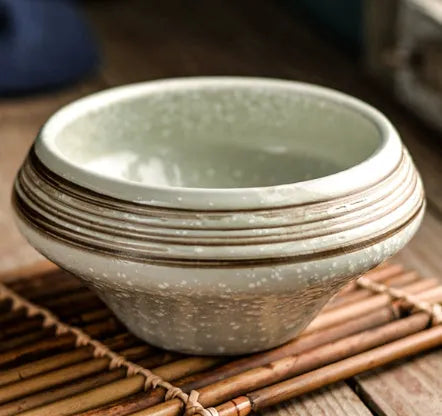 Tall porcelain Japanese soup bowl with stone conch shape and underglaze retro pattern.