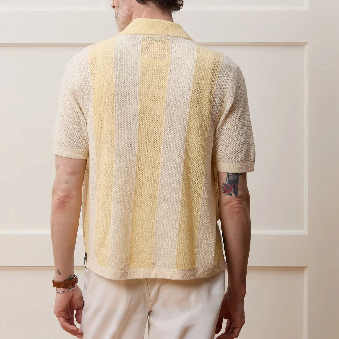 Yellow asymmetric casual polo shirt with hollow-out detail and short sleeves, made from Tencel fabric.