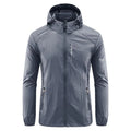 Man wearing a lightweight grey hooded nylon summer jacket outdoors.