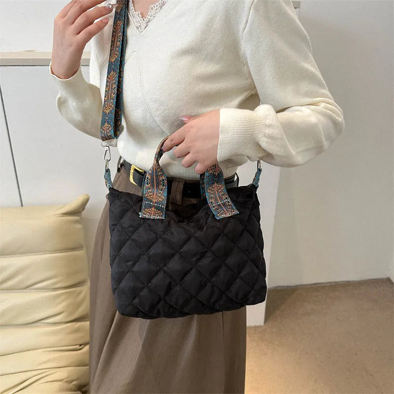 Simple shoulder messenger bag in Oxford cloth shown in multiple colours with embroidery detail and outer sandwich pocket.