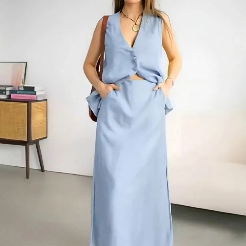 White sleeveless vest and long maxi skirt two-piece casual suit on a hanger.