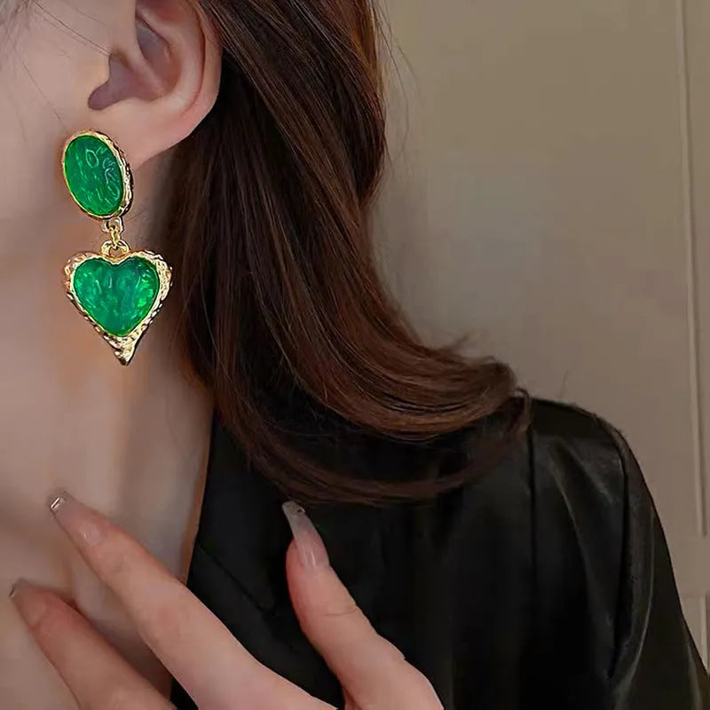 Silver pleated heart-shaped stud earrings in purple, red, green, and yellow/white colours.