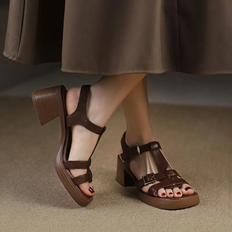 Black retro women's sandals with a T-shaped buckle, open square toe, and a chunky platform heel.