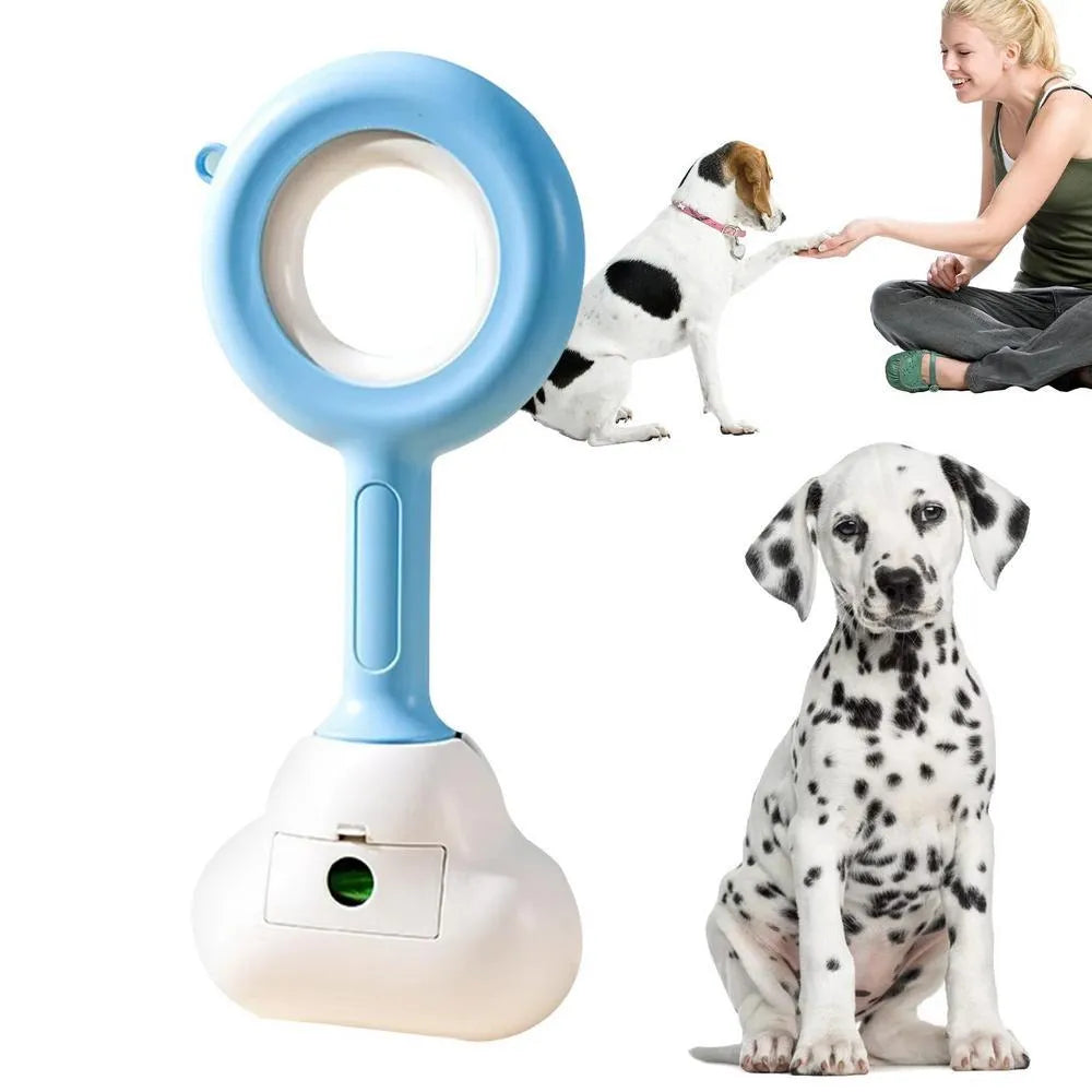 Blue and white dog pooper scooper with cloud-shaped jaw on a garden lawn.