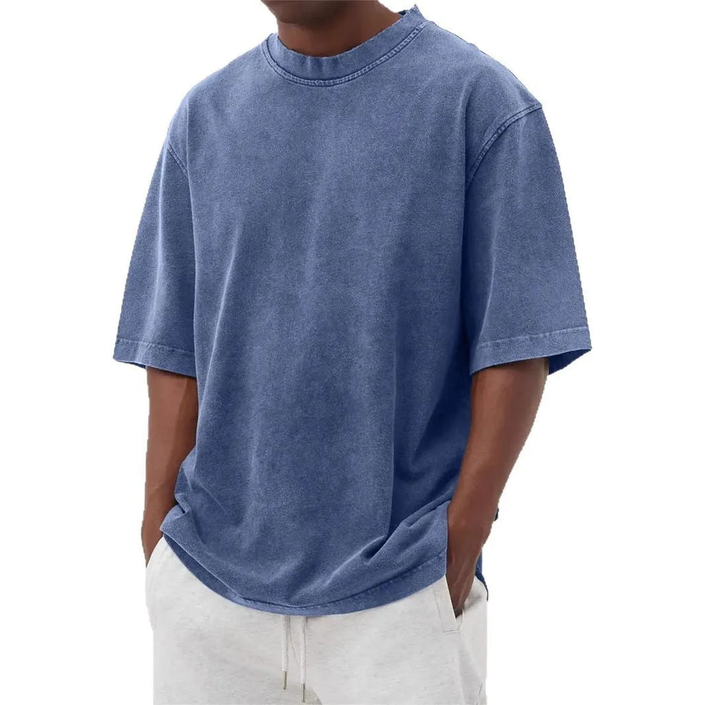 Man wearing a loose-fit stone washed solid colour t-shirt in a casual setting.