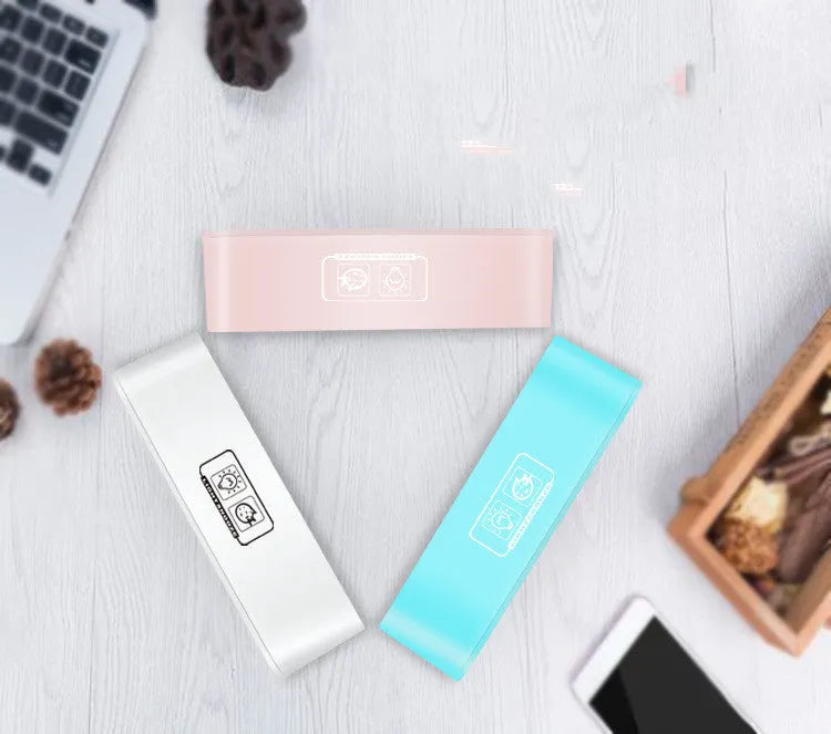 Blue rectangular LED atmosphere alarm clock with digital display on a desk.