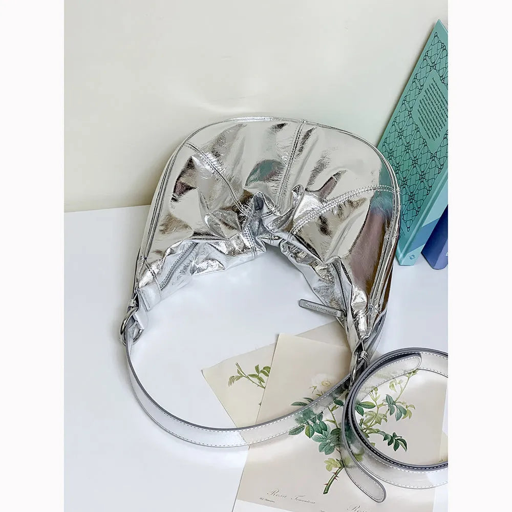 Women's soft cowhide leather shoulder bag in dumpling shape showing double straps and sandwich pocket.