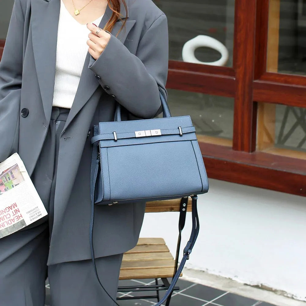 Small square genuine leather shoulder bag in almond green colour showing internal compartments