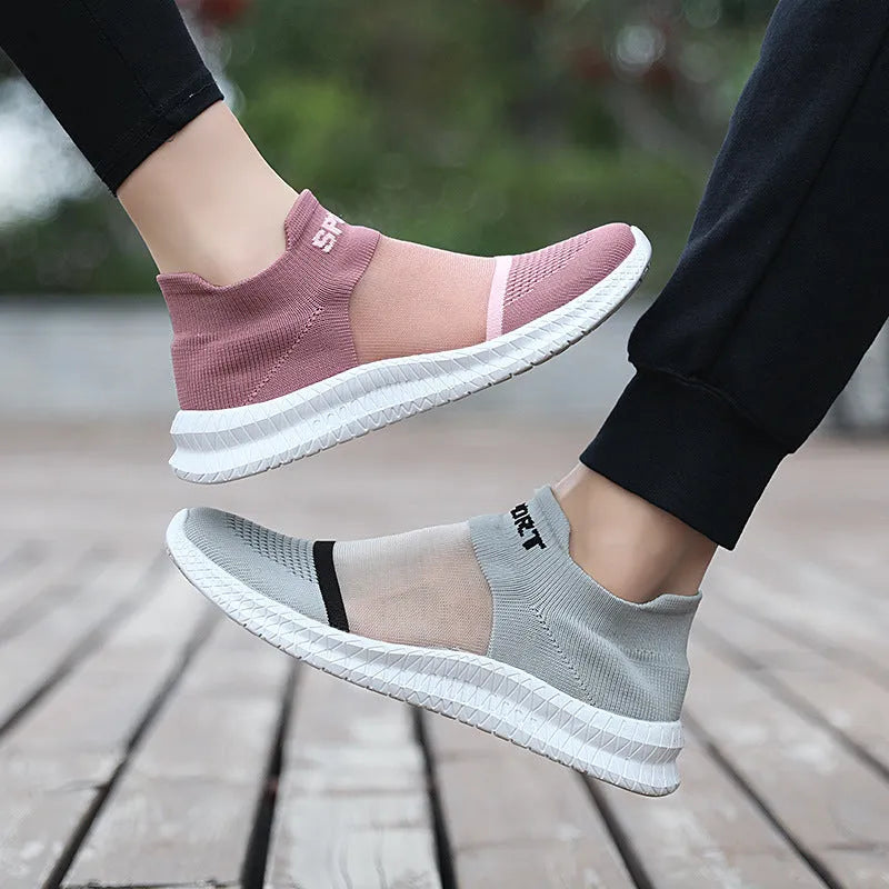 Casual grey Flyknit sock shoes with laces and a low-top MD sole, shown on a foot.