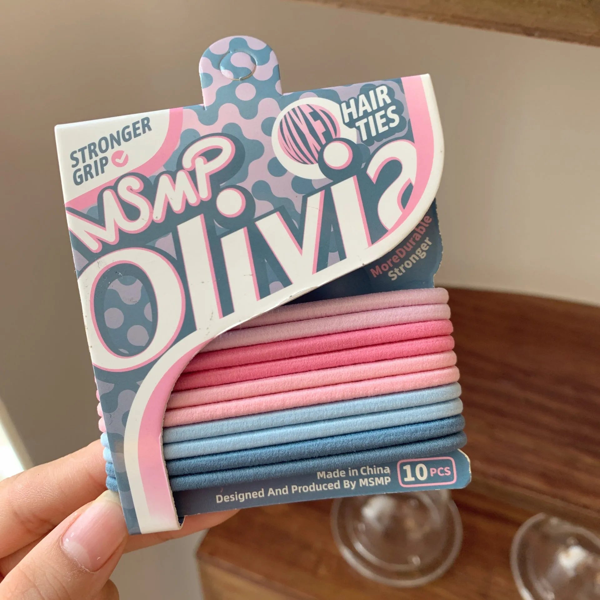 Assortment of candy coloured braided elastic hair bands on a white background.