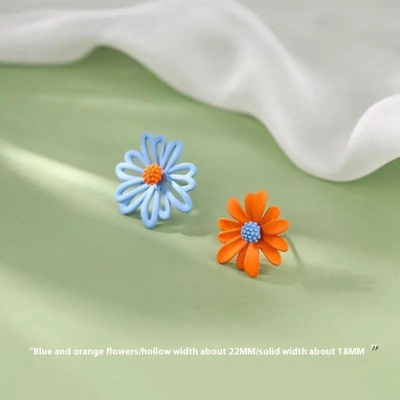 Alloy cartoon flower stud earrings in blue and orange, white and green, or yellow and white two-tone colours.