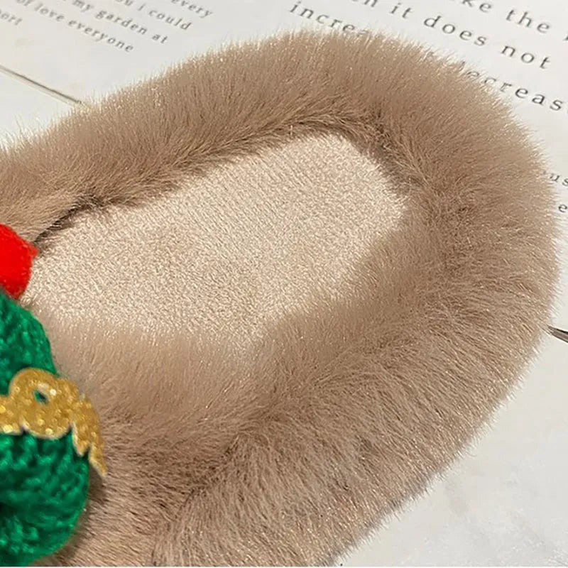 Women's Christmas hat themed slippers in faux plush with a rubber sole and cotton lining.
