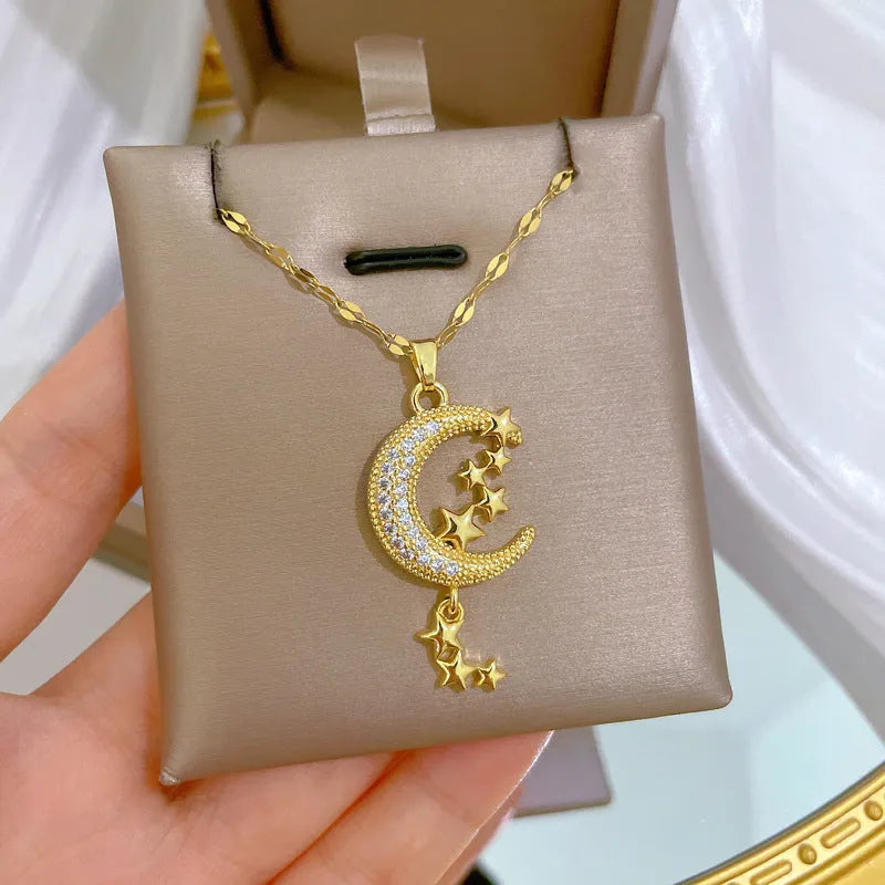 Geometric moon necklace with tassel detail in stainless steel and copper materials