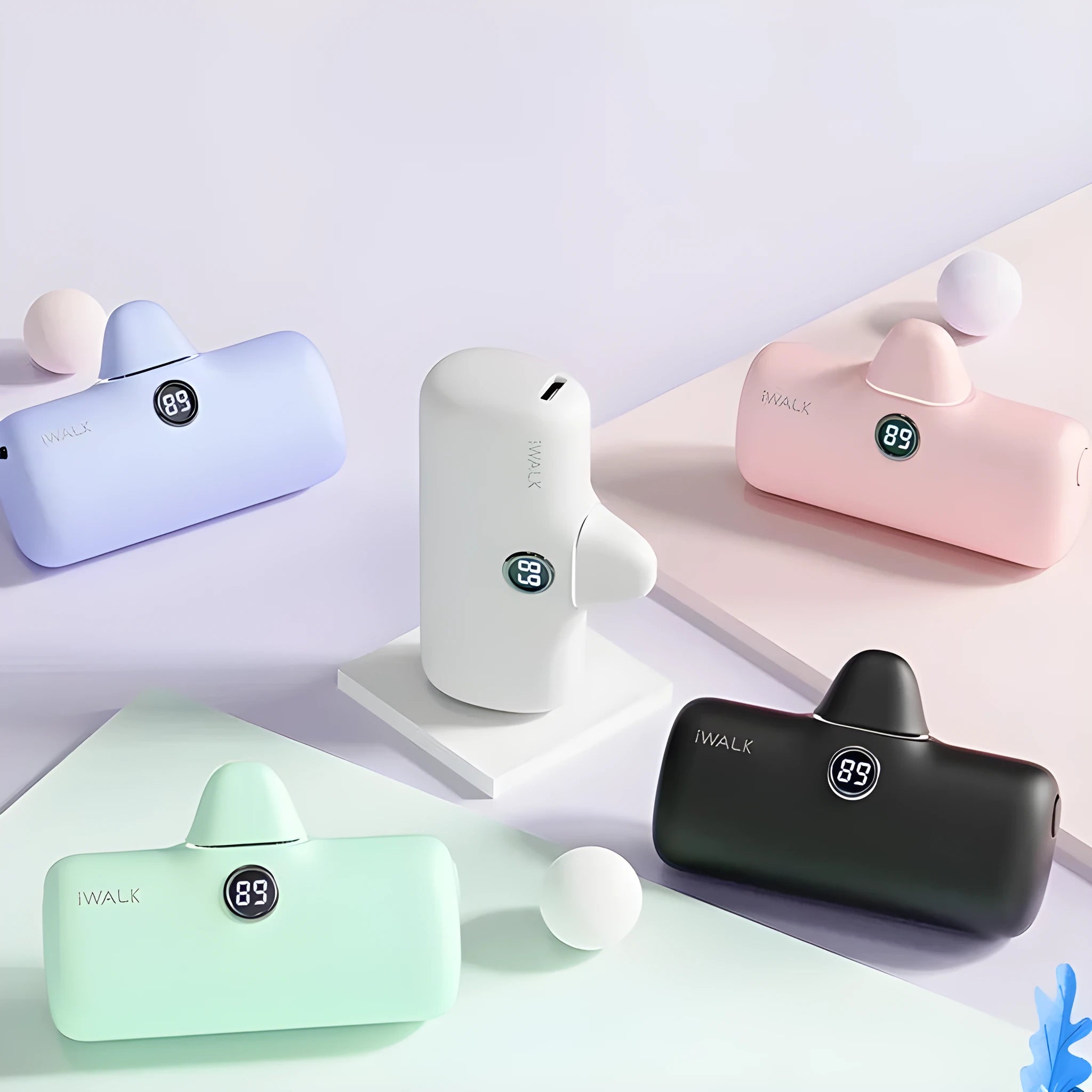 Compact lipstick-shaped portable power bank in multiple colours showing size and display screen