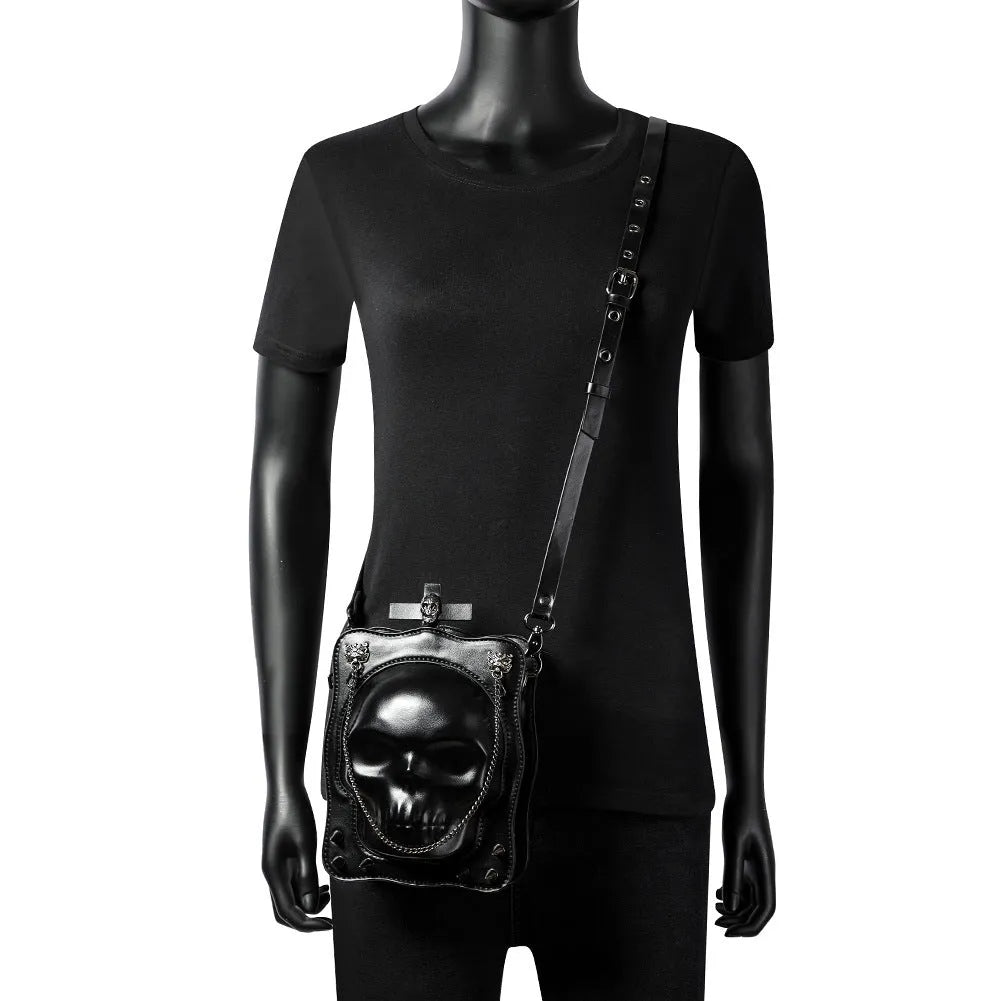 Black gothic skull shoulder bag with square messenger shape and decorative metal details