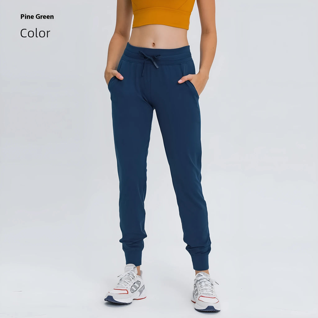 Woman wearing high-waisted blue yoga pants with a drawstring waistband for fitness.