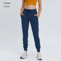 Woman wearing high-waisted blue yoga pants with a drawstring waistband for fitness.