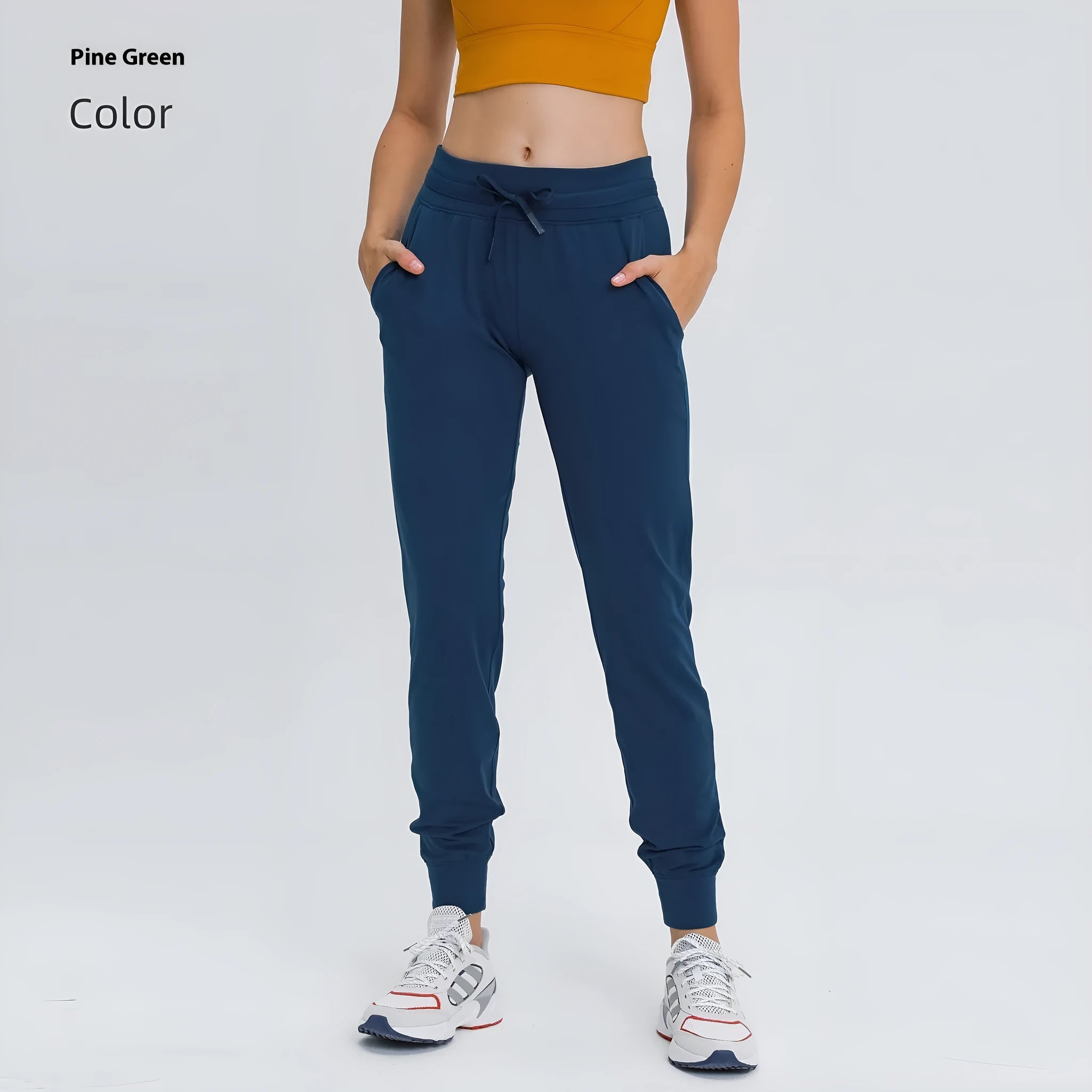 Woman wearing high-waisted blue yoga pants with a drawstring waistband for fitness.